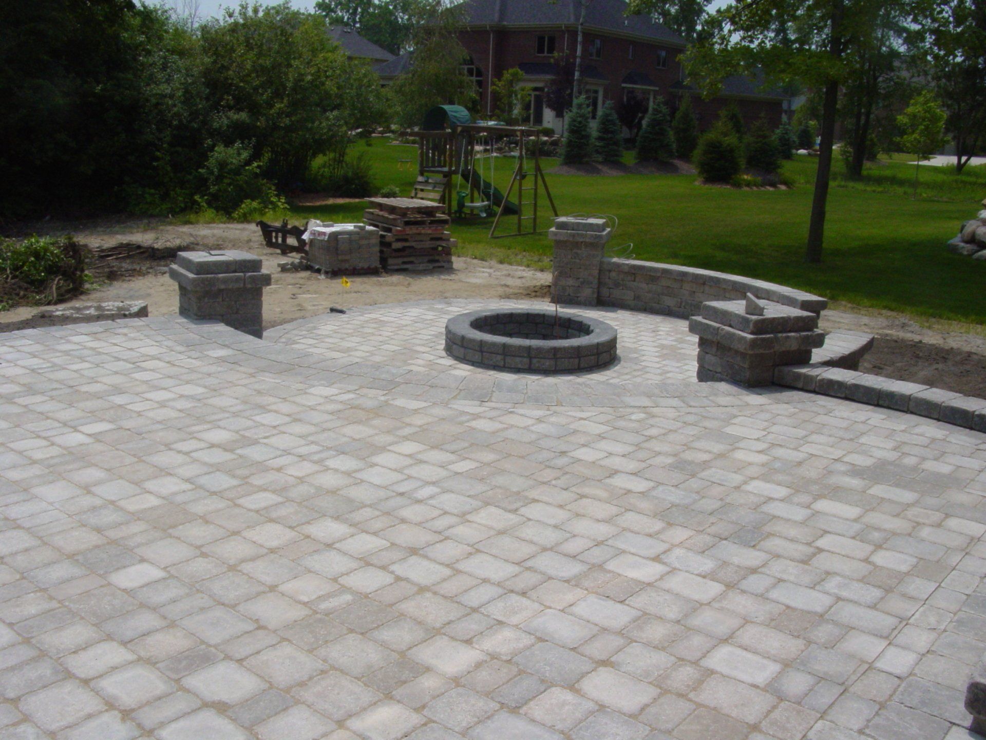 There is a fire pit in the middle of the patio.