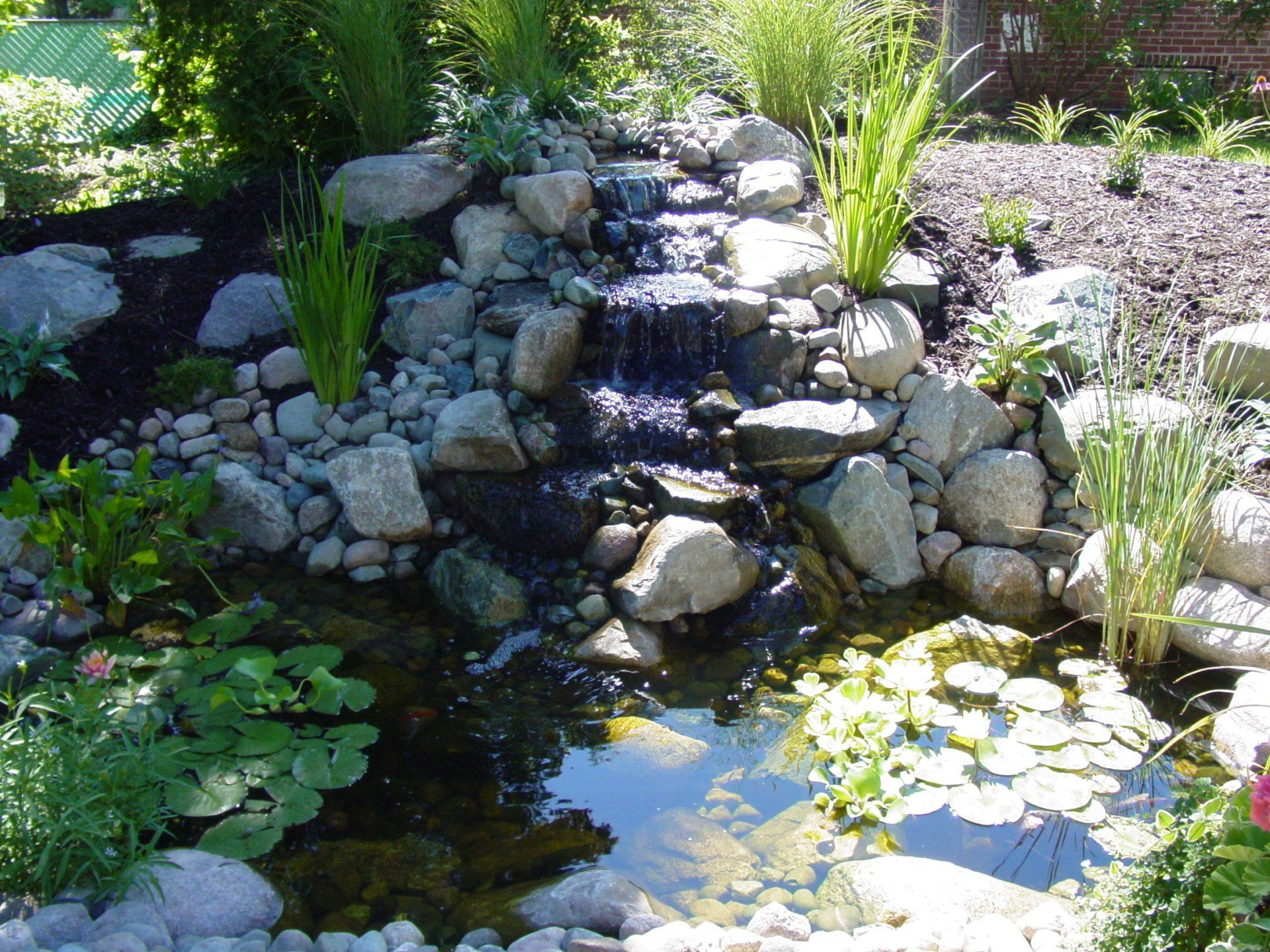 A pond with a waterfall in the middle of it