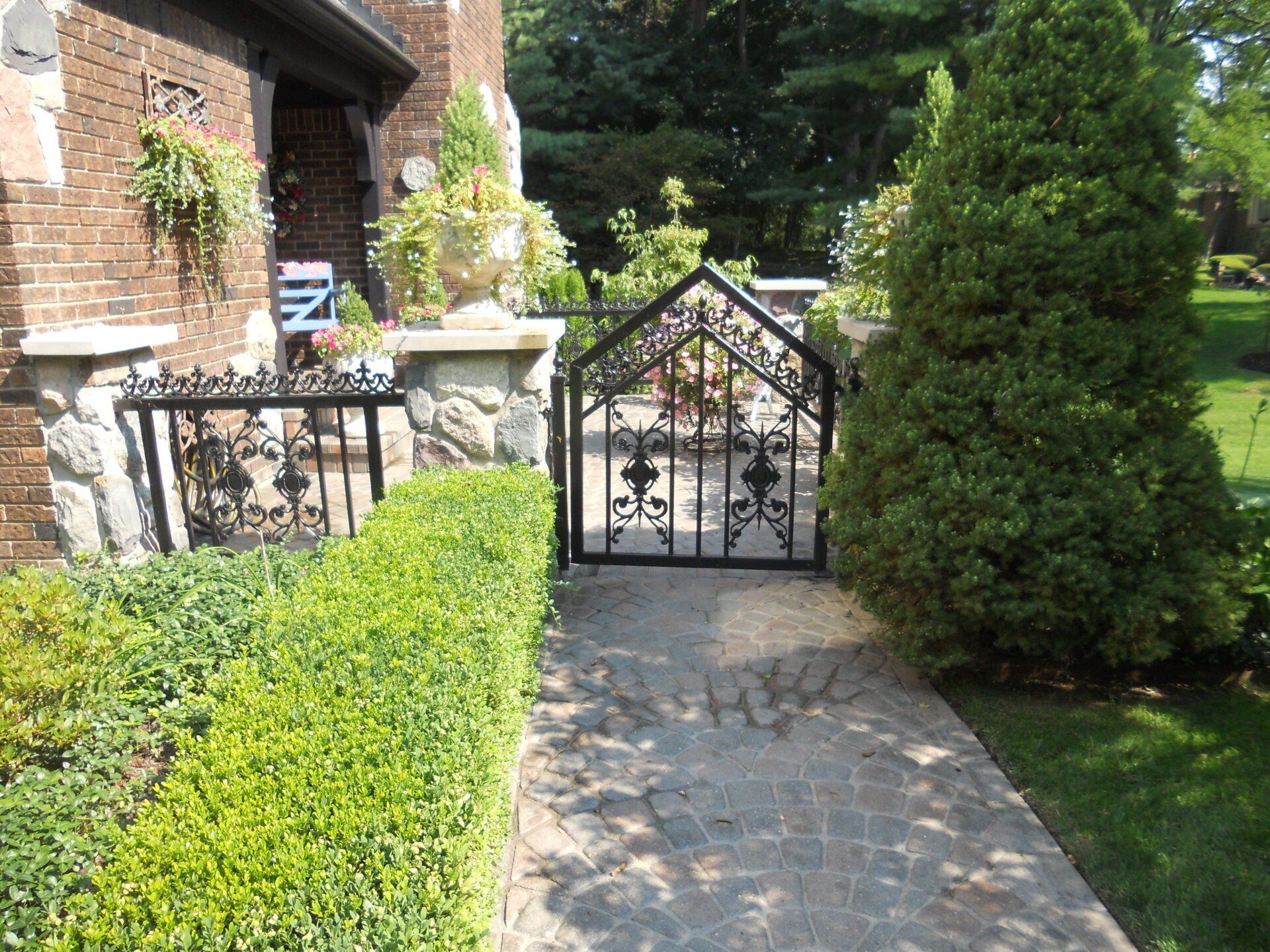 A brick house with a wrought iron gate in front of it