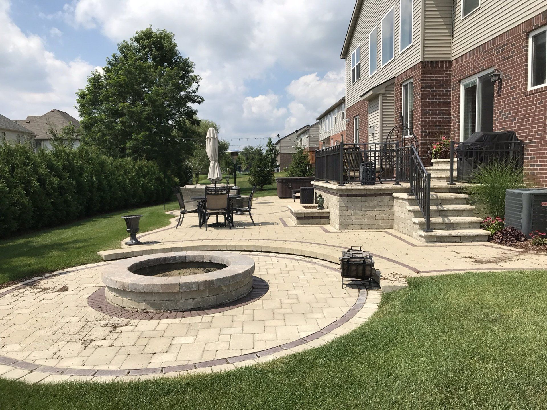 There is a fire pit in the middle of the backyard.