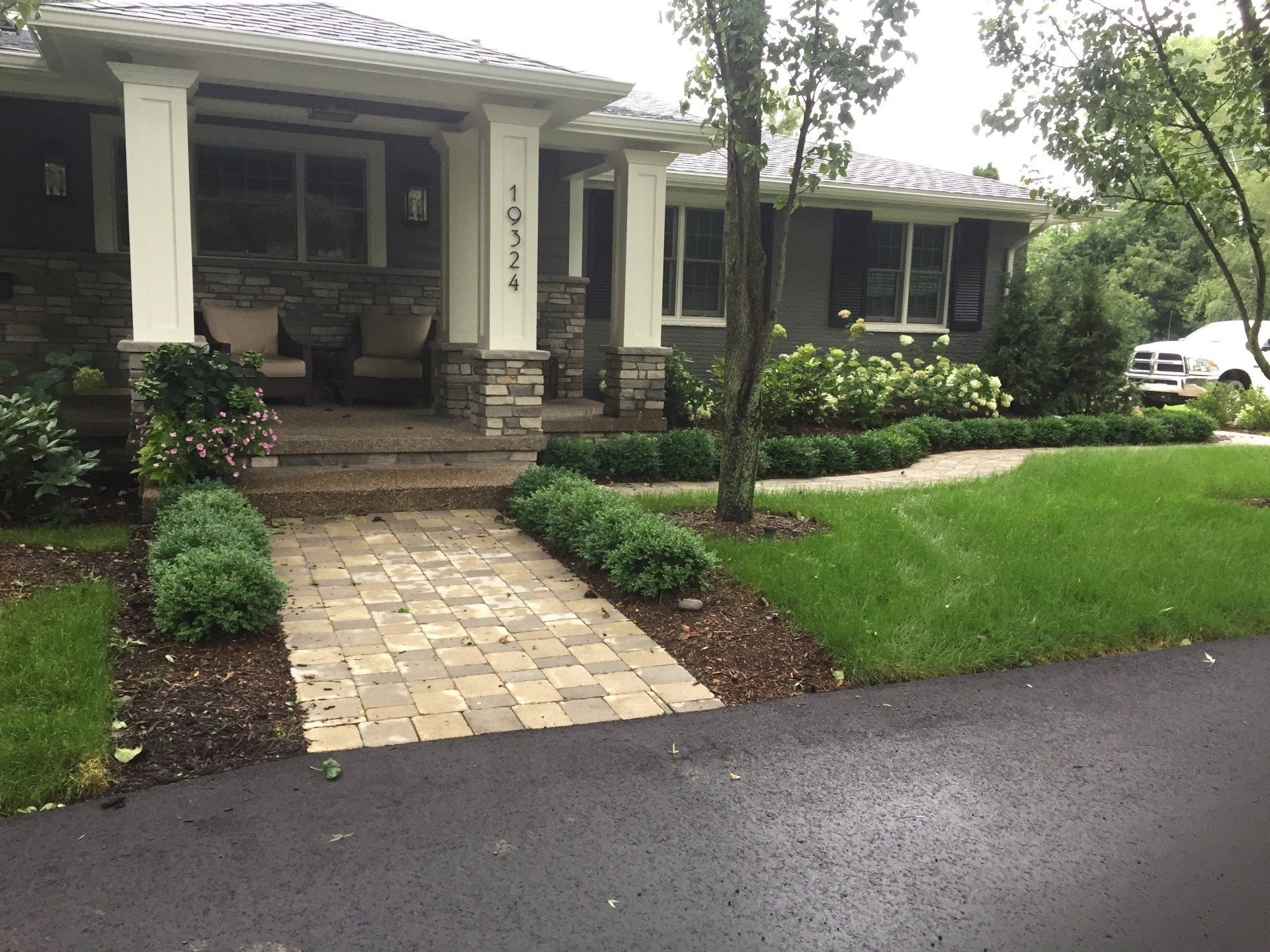 A house with a brick walkway leading to the front door