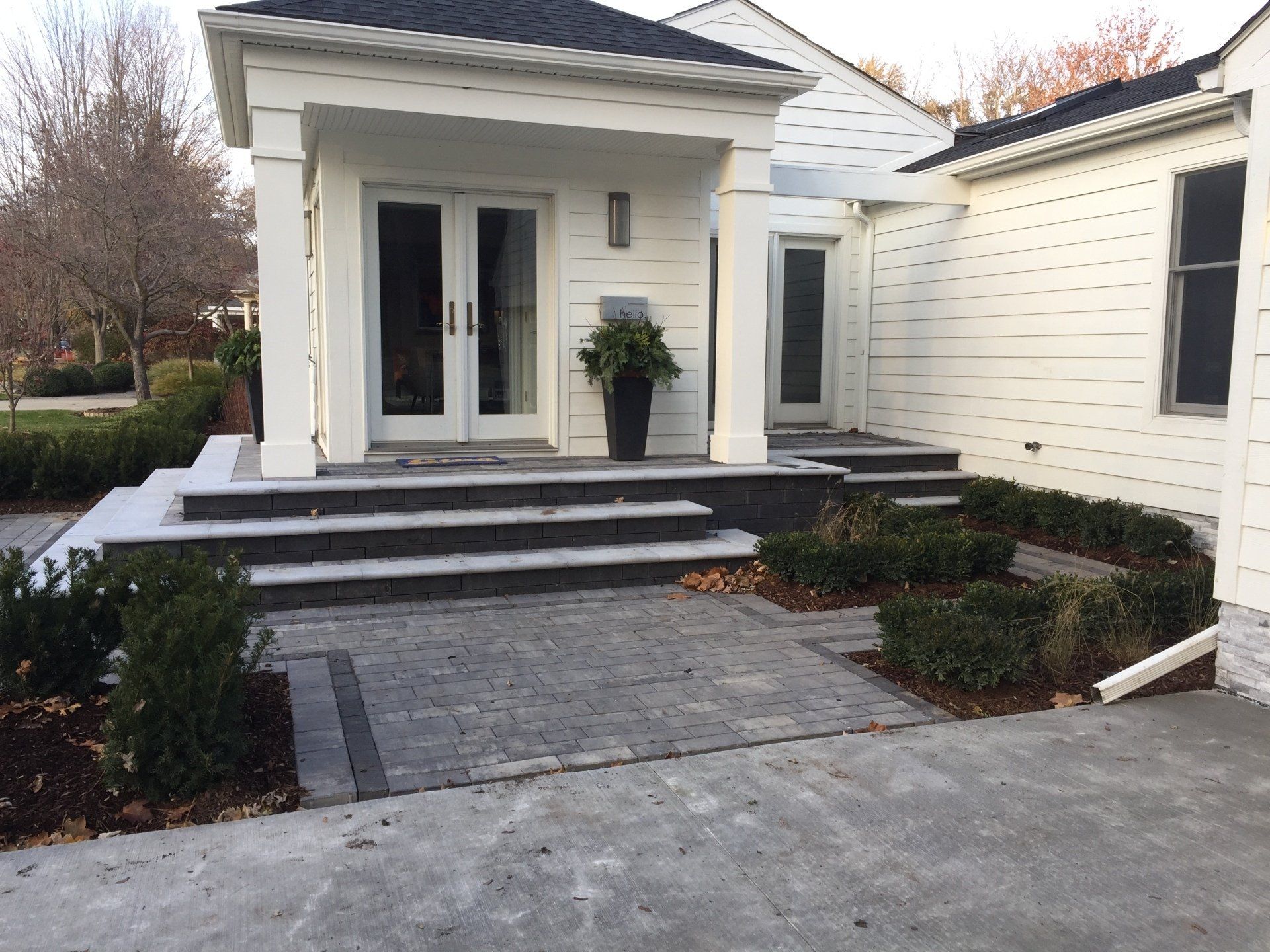 A white house with stairs leading up to the front door