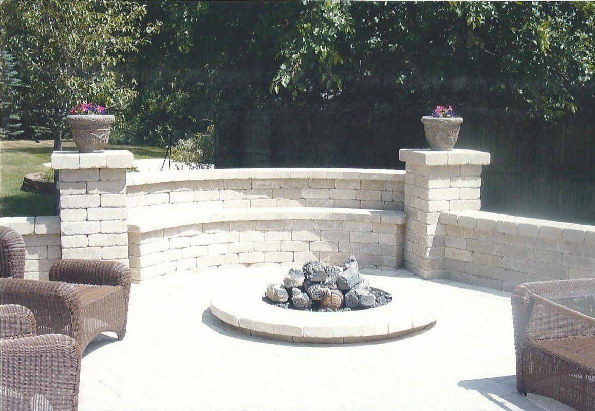 A fire pit sits in the middle of a patio