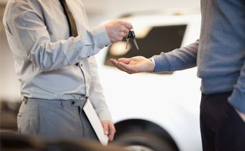 Man giving keys to another man — Car Rental in Kingston,NY Man giving keys to another man — Car Rental in Kingston,NY