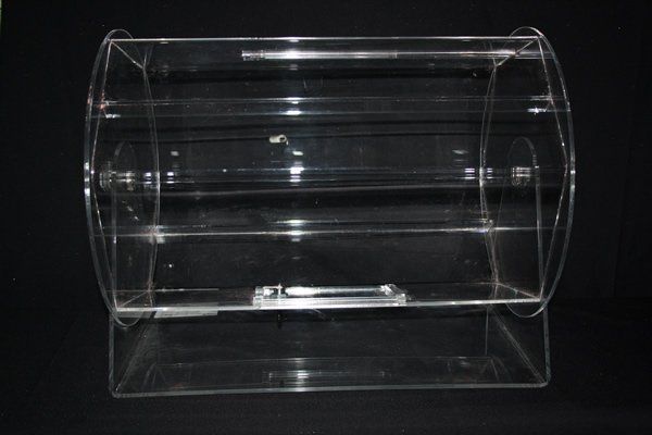 Clear cylindrical plastic display container on a black background