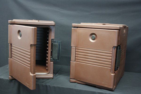 Two brown metal lunch boxes, one open and one closed, on a gray background