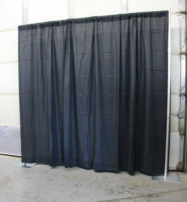 Black curtain divider hanging in an industrial indoor space