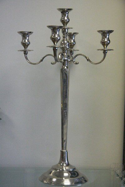 Silver five-arm candelabra on a plain background