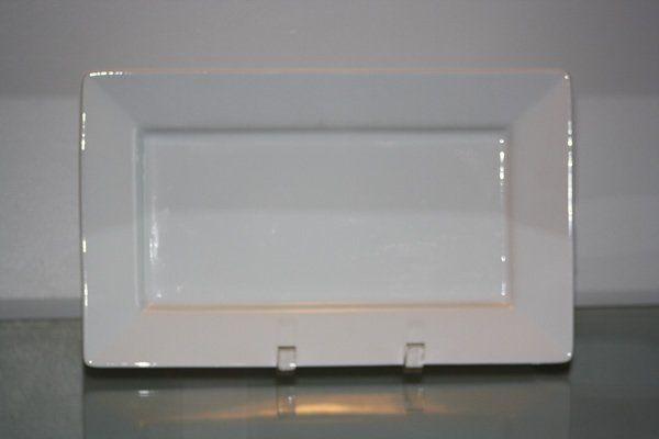 White rectangular picture frame with a recessed center on a reflective surface
