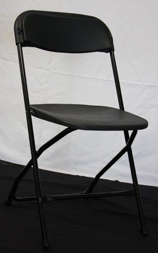 Black folding chair against a white backdrop