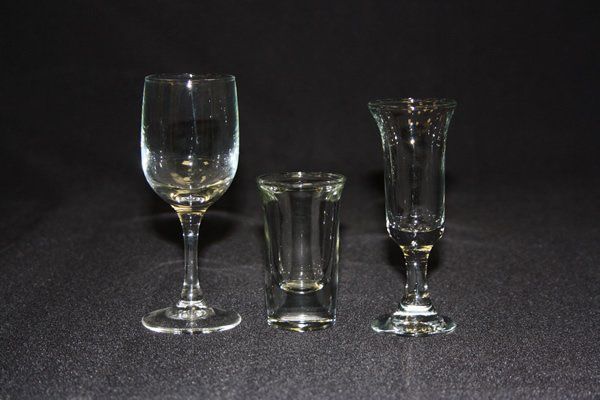 Three clear glass goblets on a dark background, arranged side by side.
