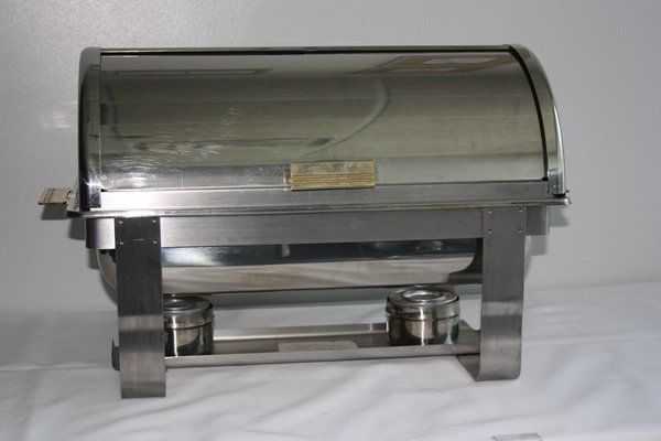 Stainless steel food warmer with a curved glass lid and side handles on a white background