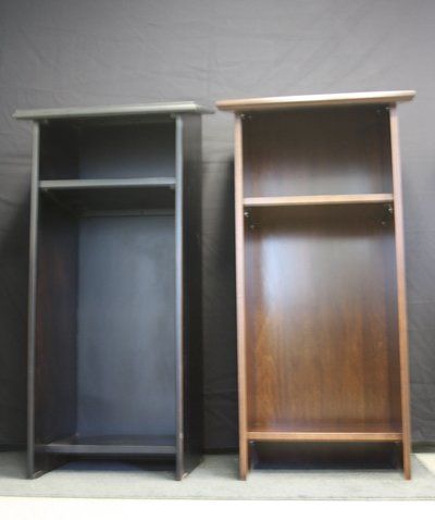 Two small wooden shelving units, one dark gray and one brown, standing side by side against a gray background