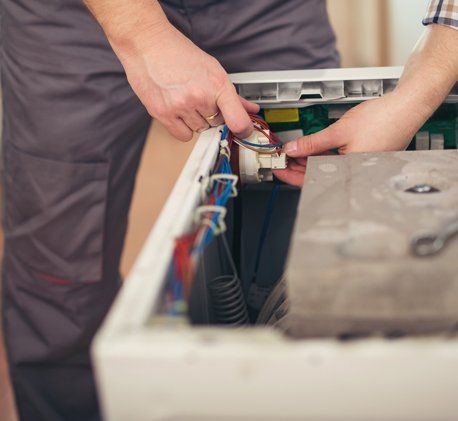 Home Repairs — Technician Repairing A Washing Machine in Seattle, WA Home Repairs — Technician Repairing A Washing Machine in Seattle, WA
