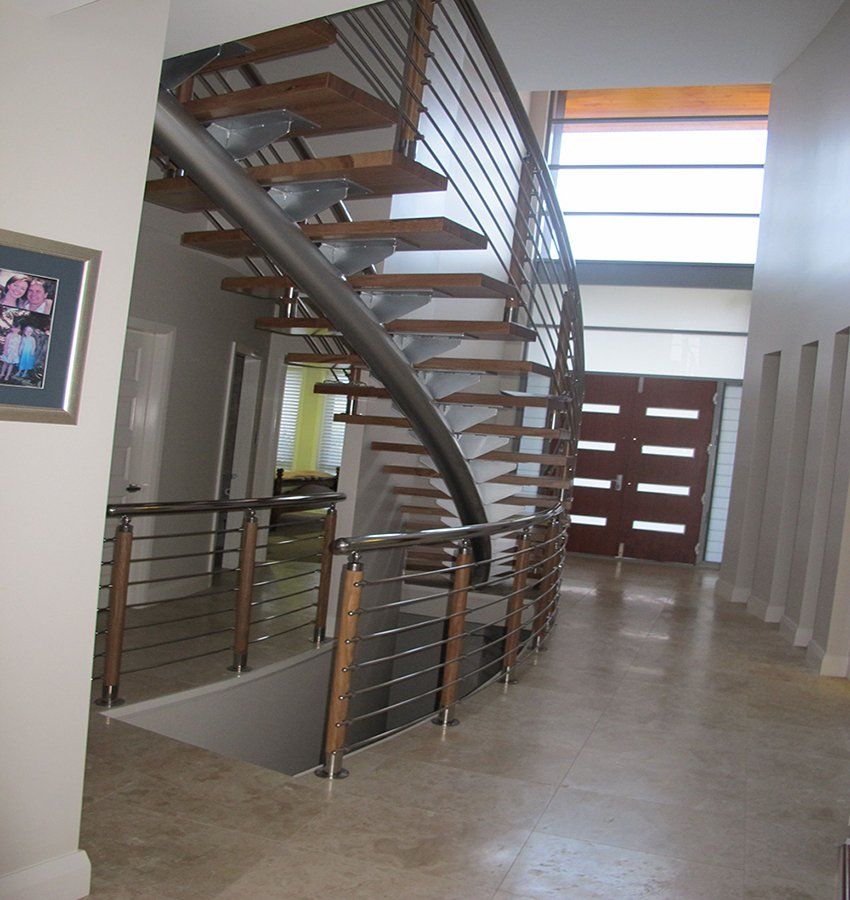 A staircase in a hallway with a picture on the wall above it