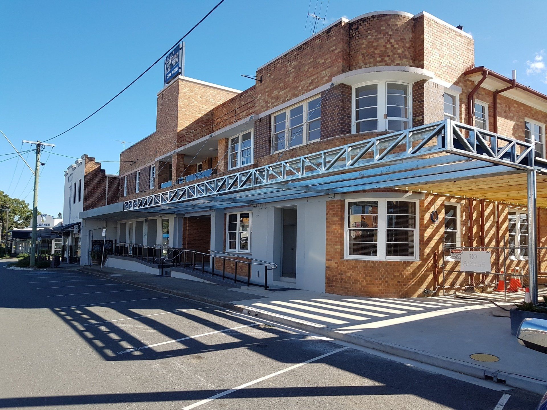A large brick building with a canopy over it is being remodelled.