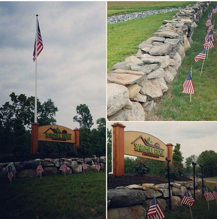 A sign that says sanctuary is next to a stone wall