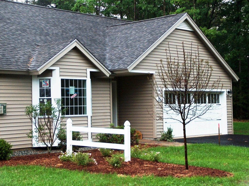 A house with a white fence in front of it