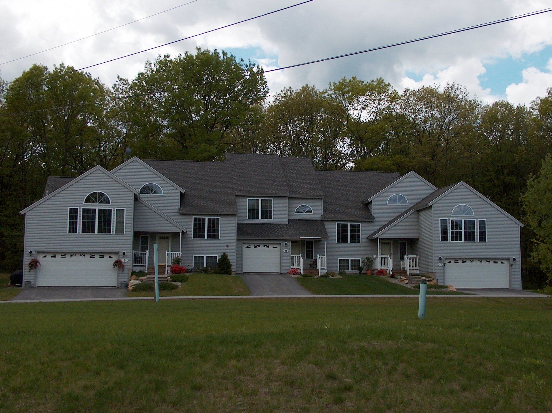 A large house with a lot of windows and garage doors