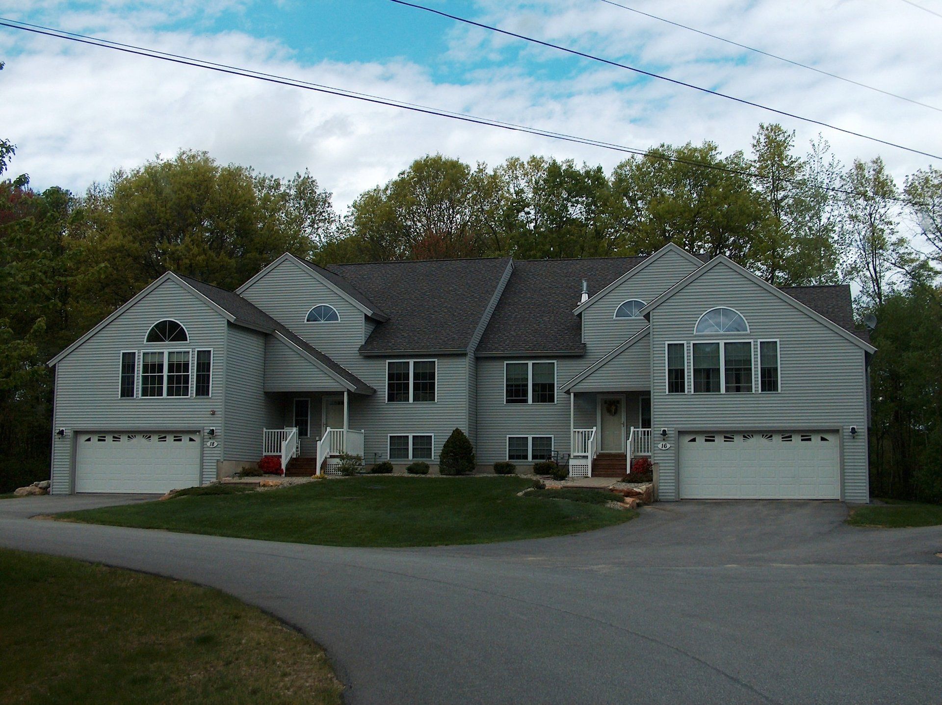 A large house with two garages and a driveway