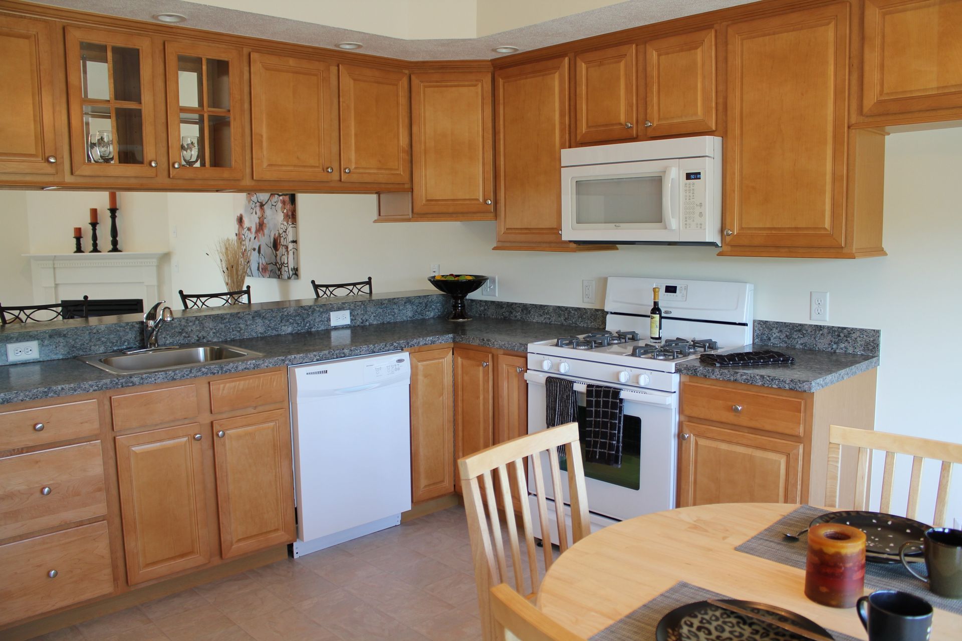 A kitchen with wooden cabinets and granite counter tops