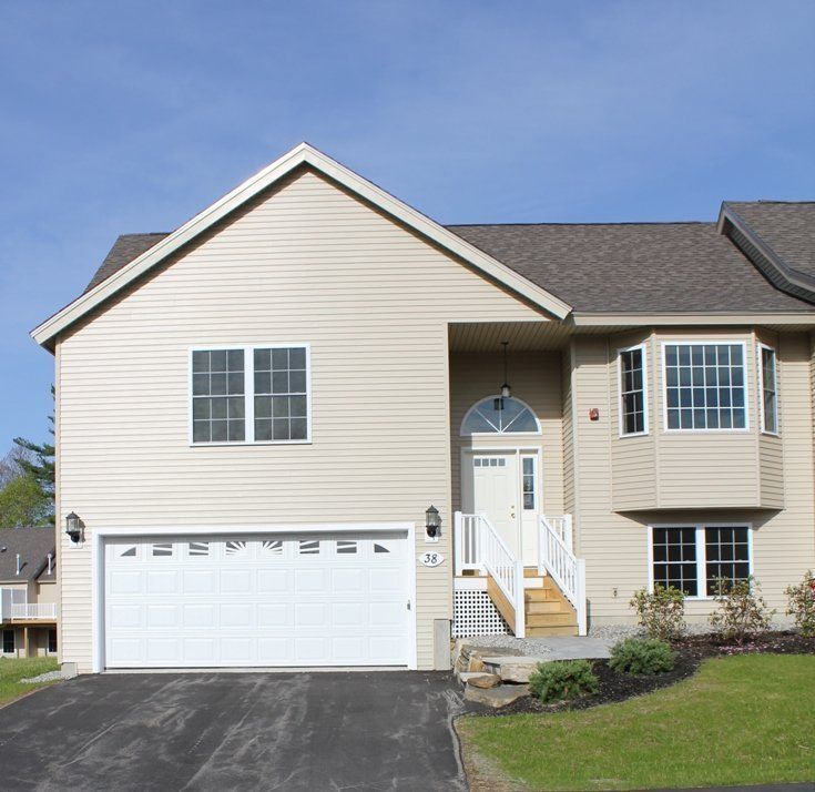 The front of a house with a white garage door