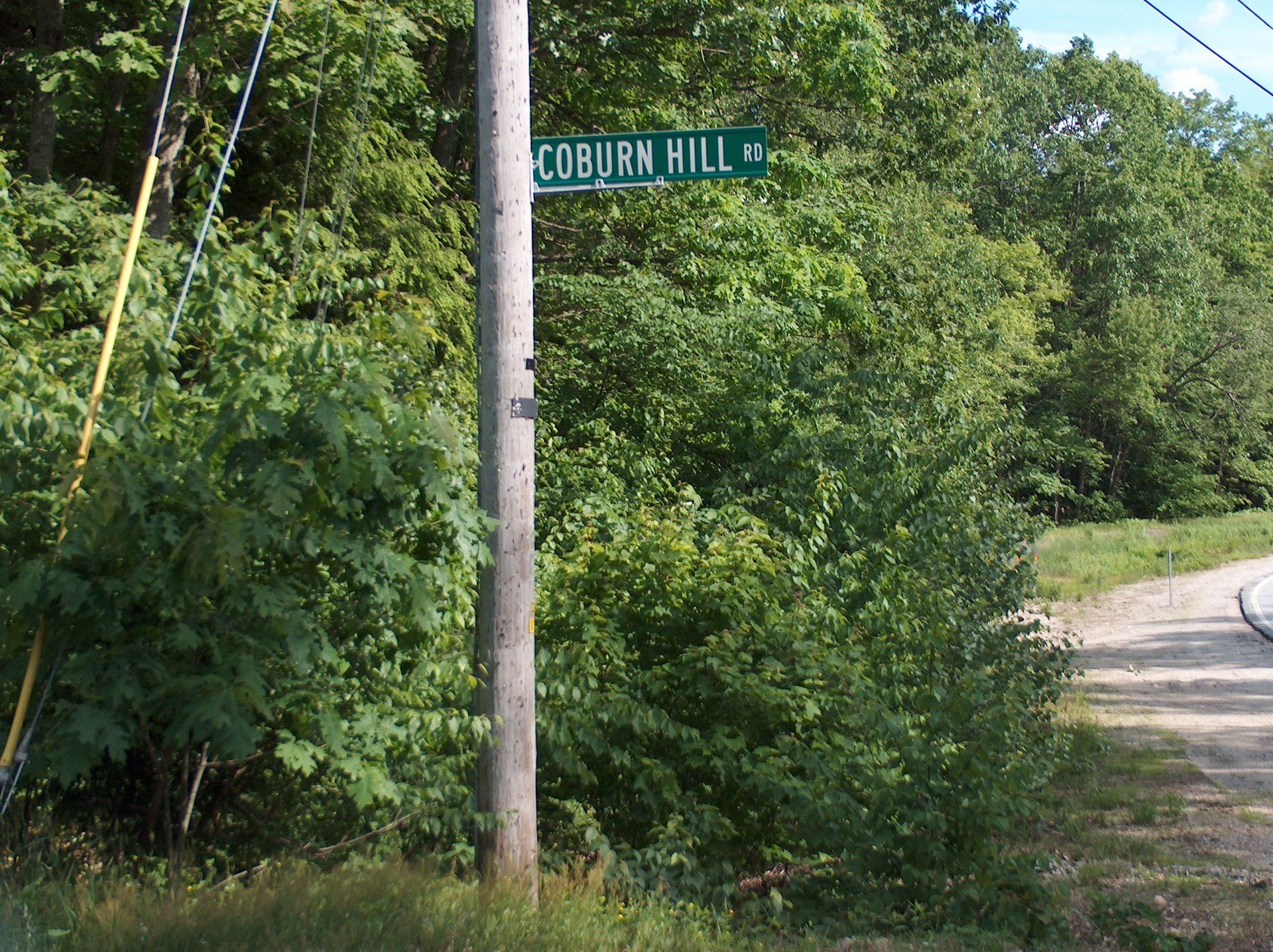A street sign for coburn hill is on a pole