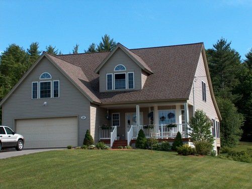 A large house with a car parked in front of it