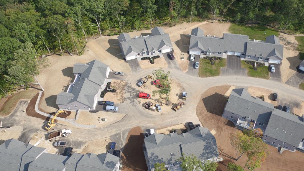 An aerial view of a residential area with houses and trees