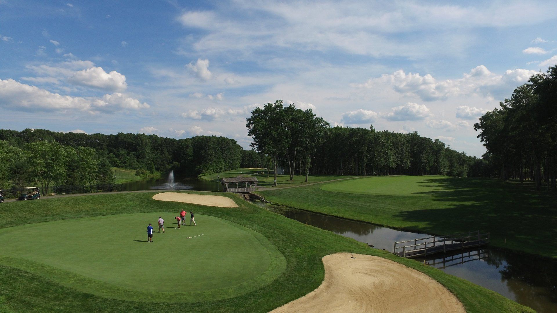A group of people are playing golf on a golf course.