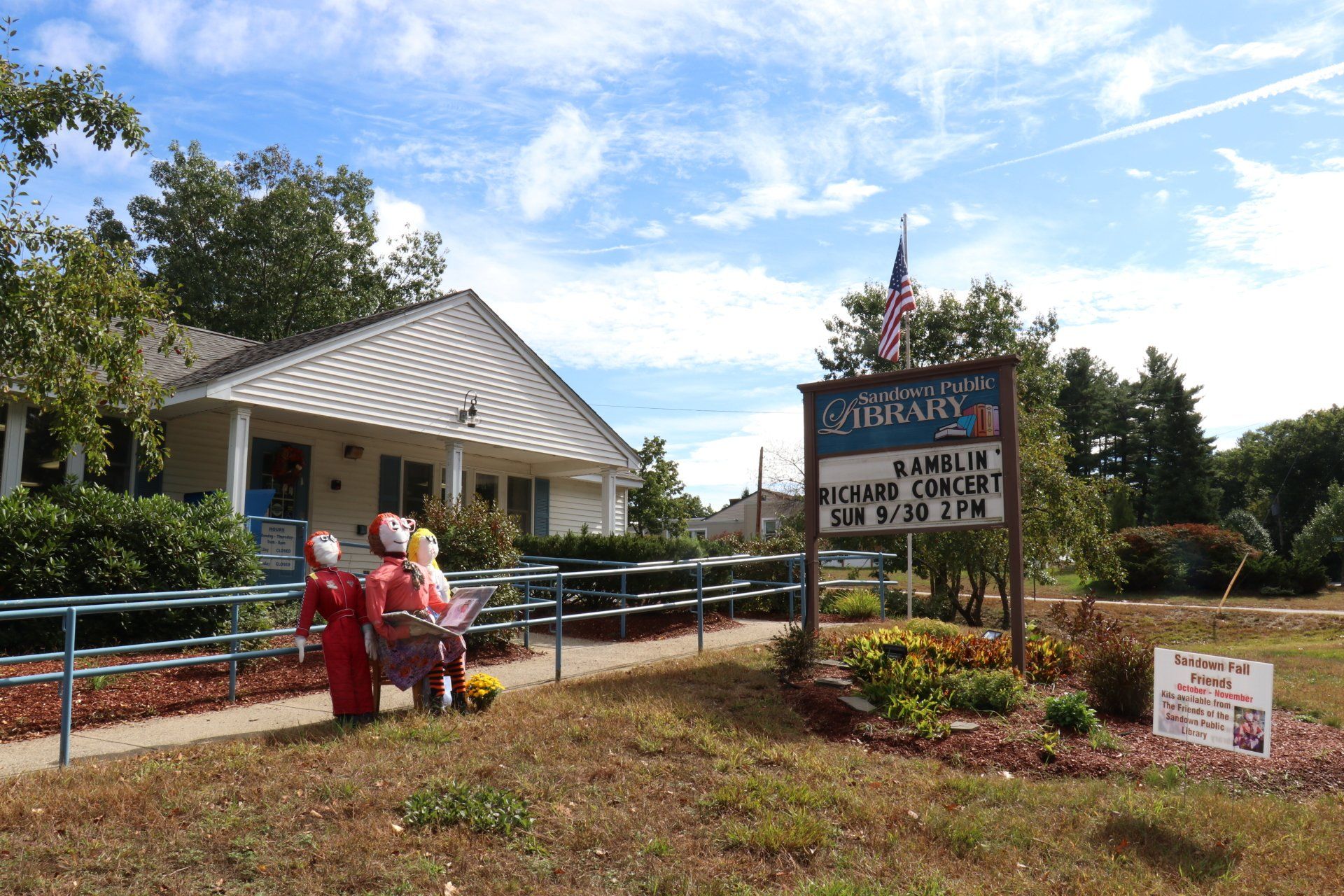 A sign in front of a building that says library