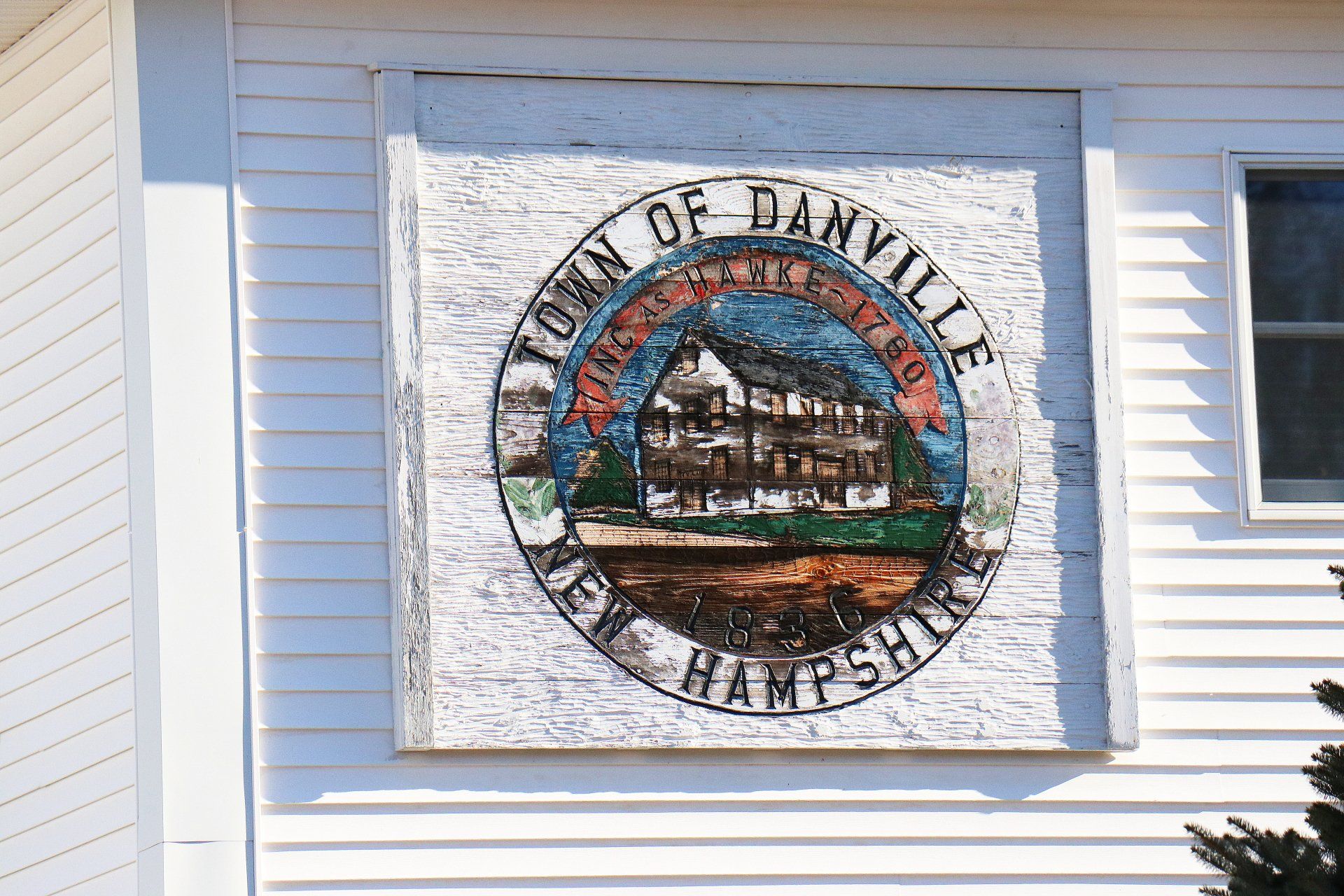 A sign on the side of a building that says town of danville