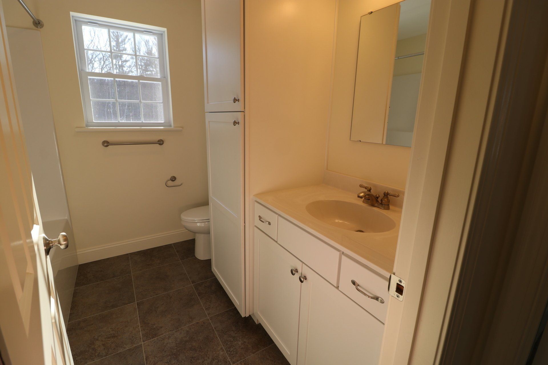 A bathroom with a sink , toilet and mirror