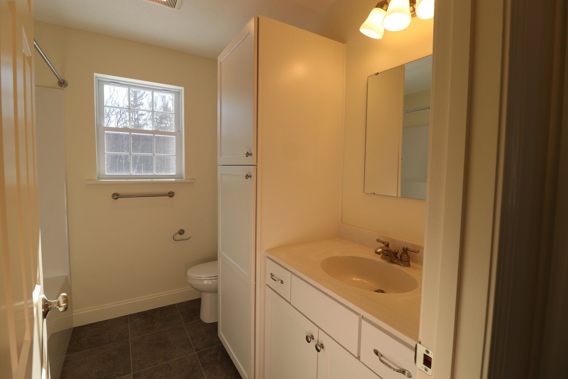 A bathroom with a sink , toilet , and mirror