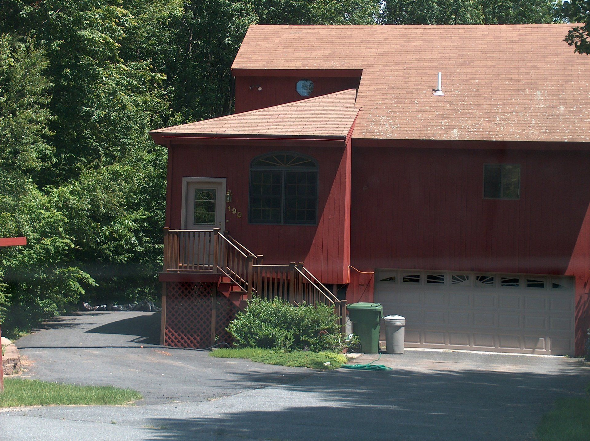 A red house with a roof that has the number 1 on it