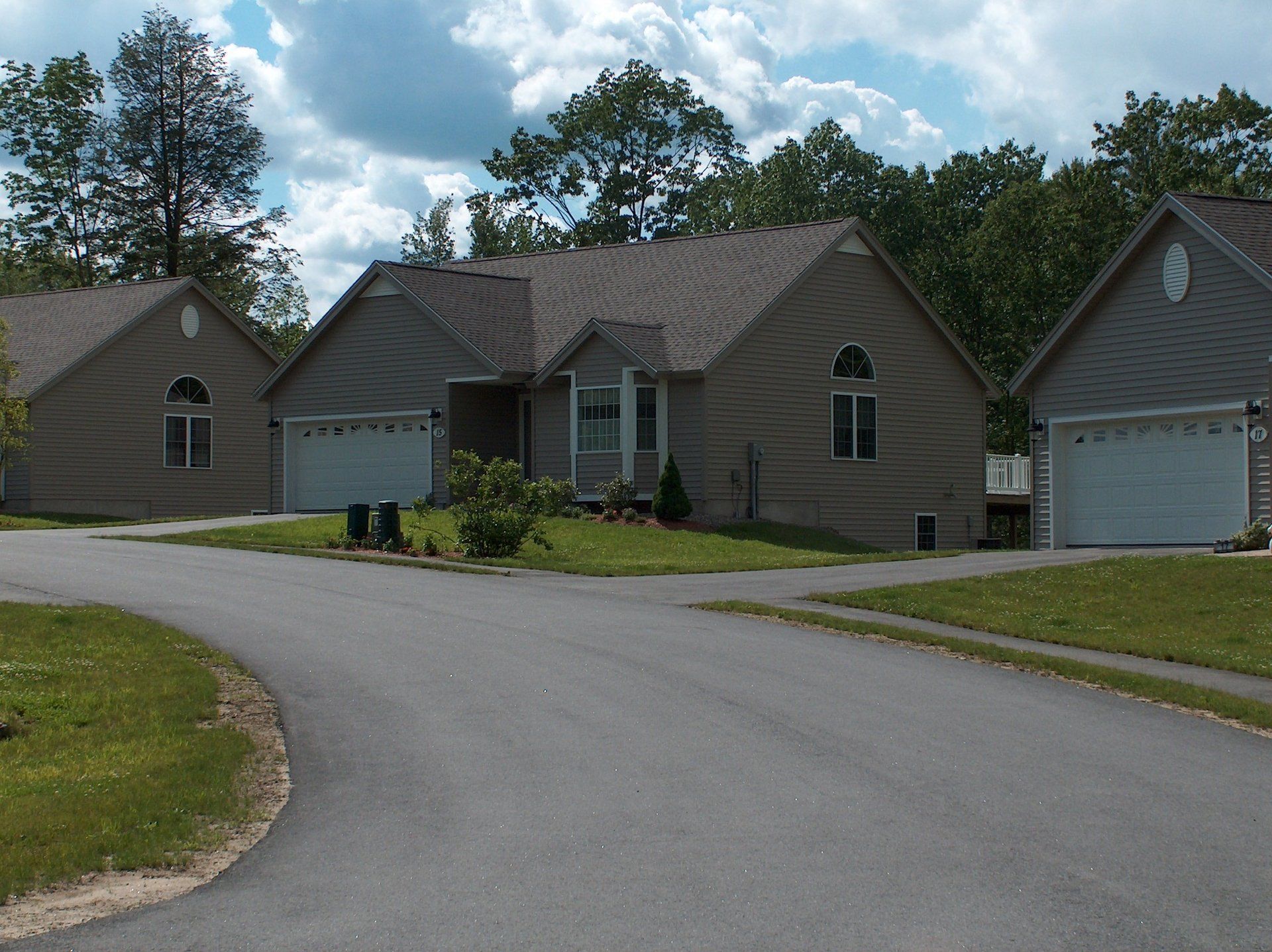 A row of houses with white garage doors in a residential area