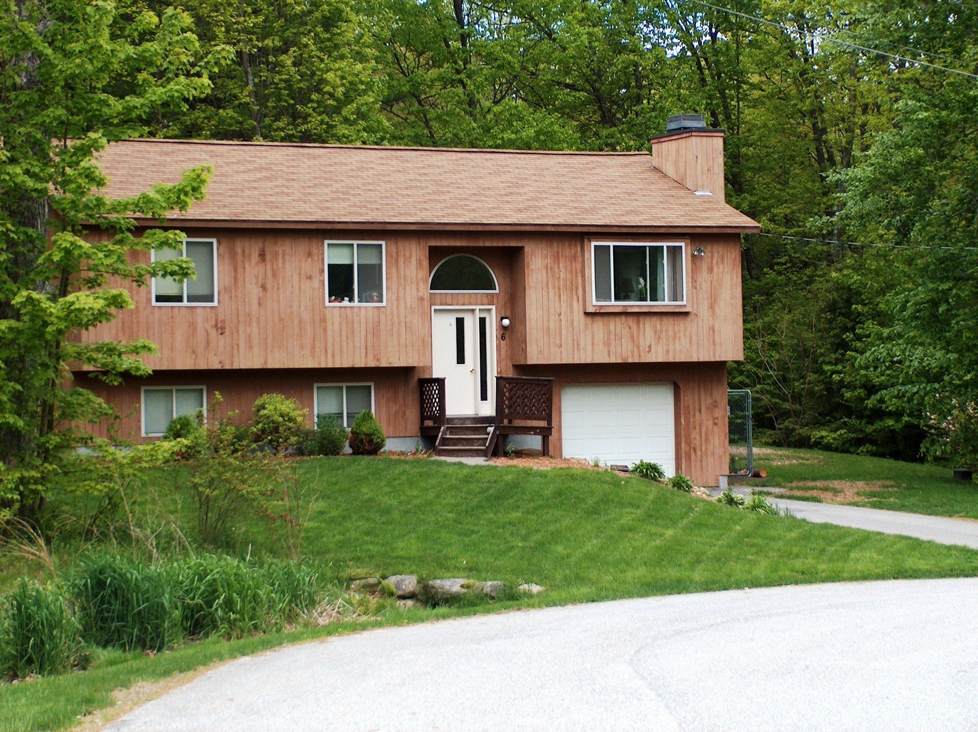 A house with a brown roof and a white door