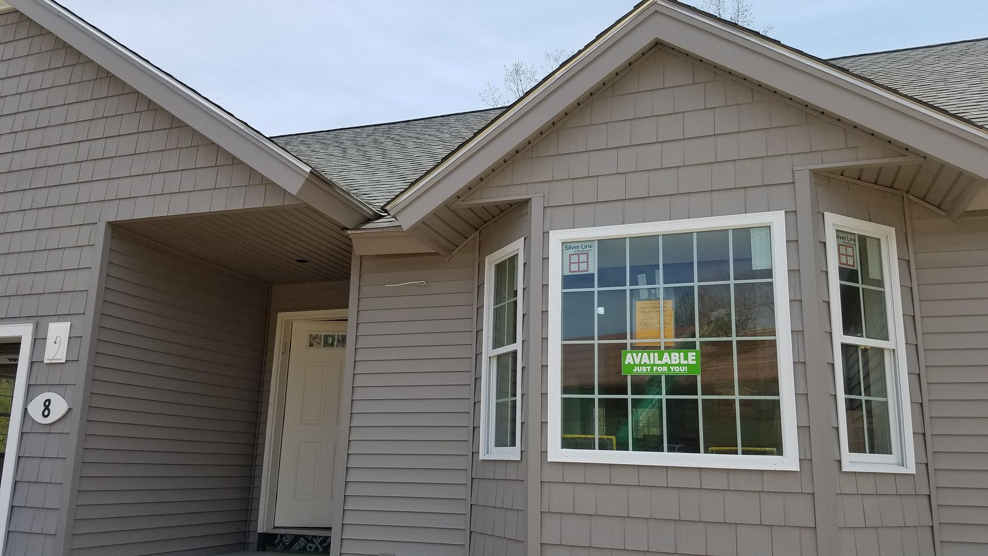 A house with a for sale sign on the window