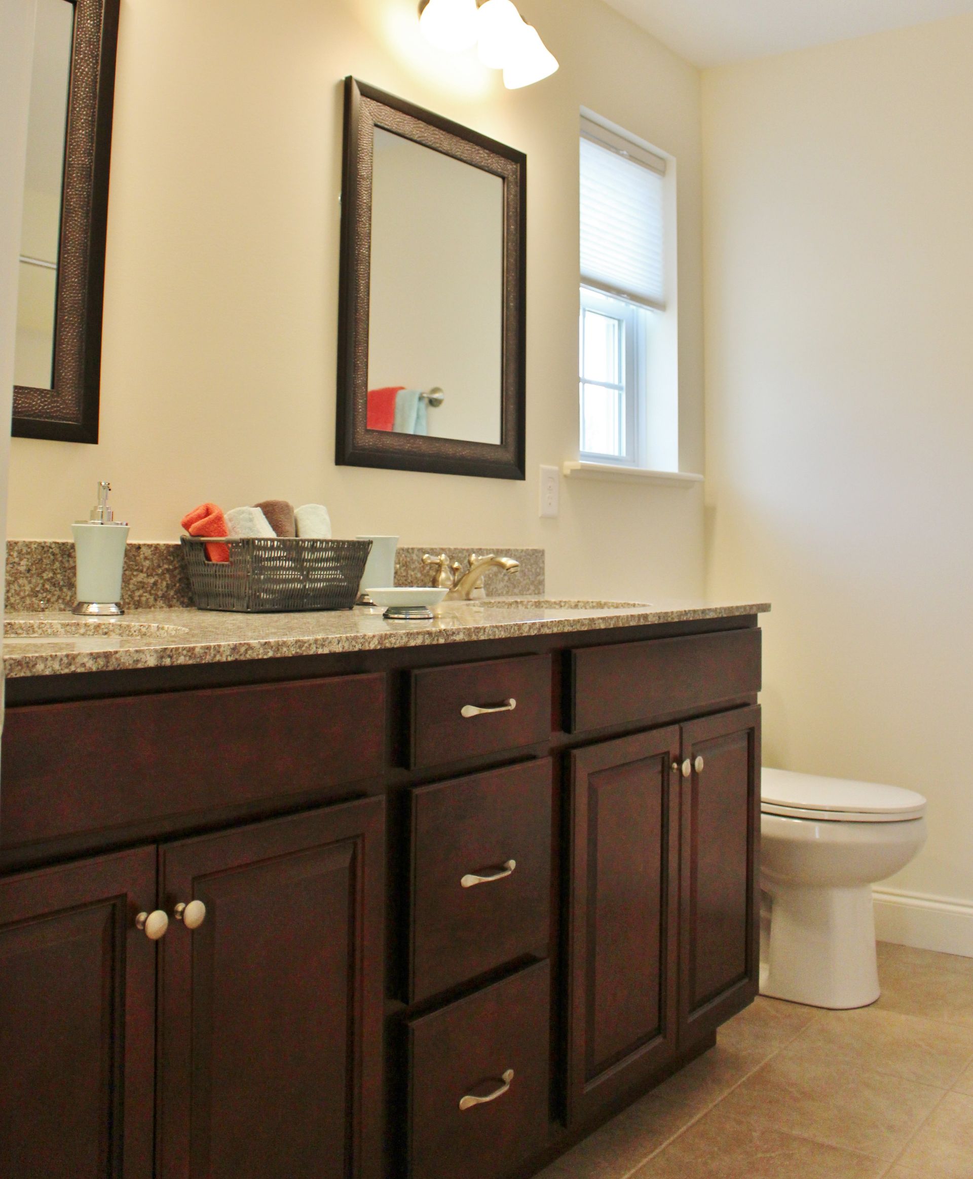 A bathroom with a toilet a sink and a mirror