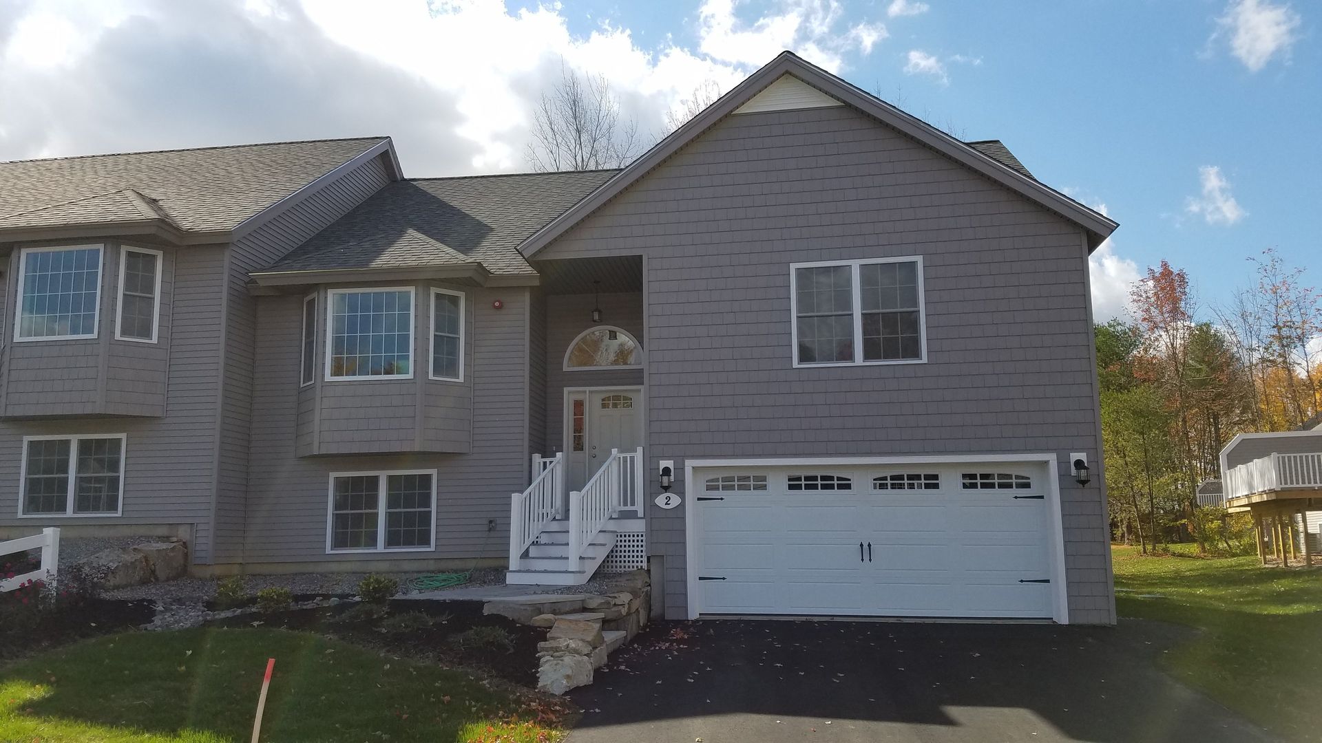 A large brick house with a white garage door