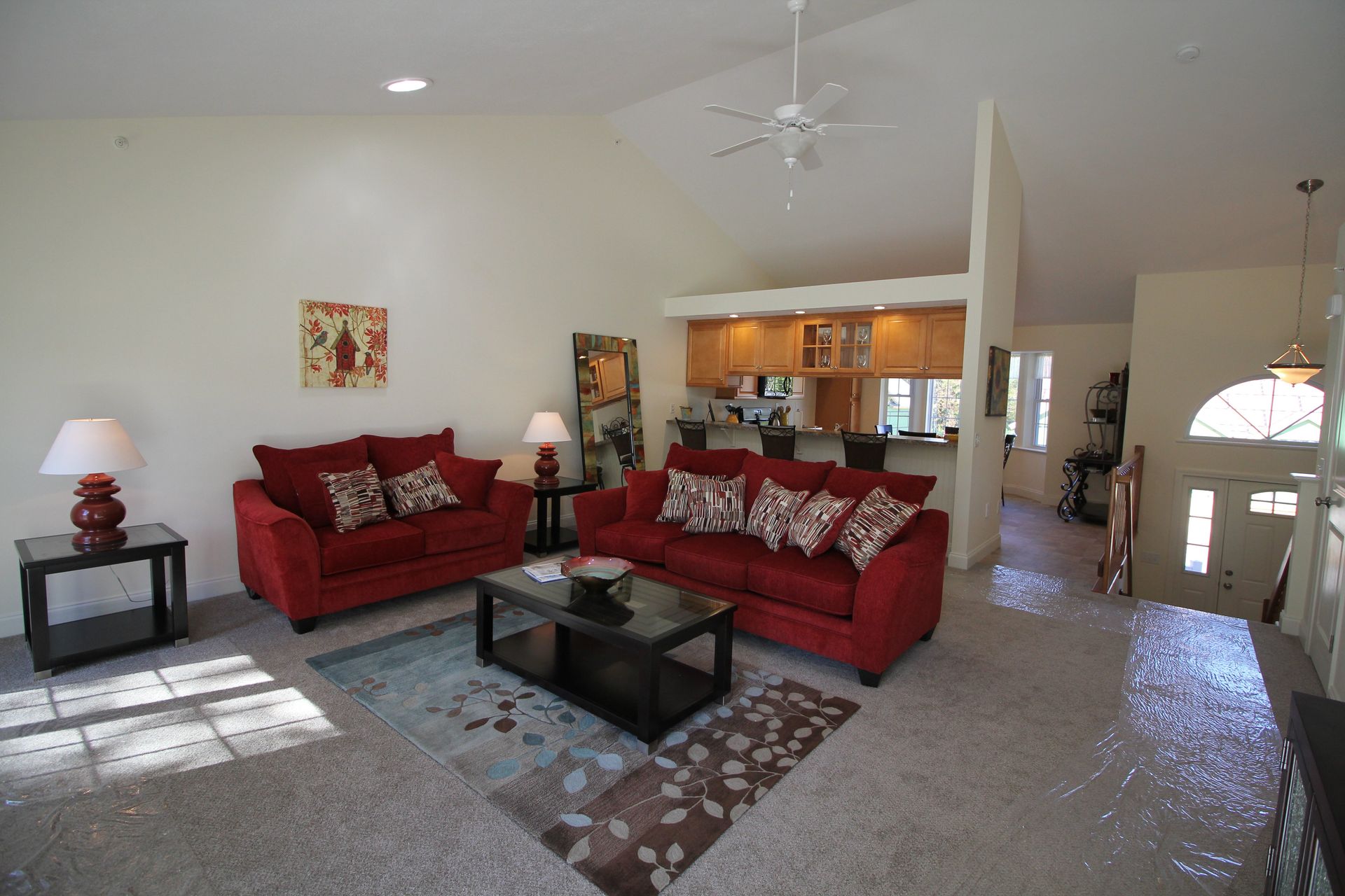 A living room with two red couches and a coffee table