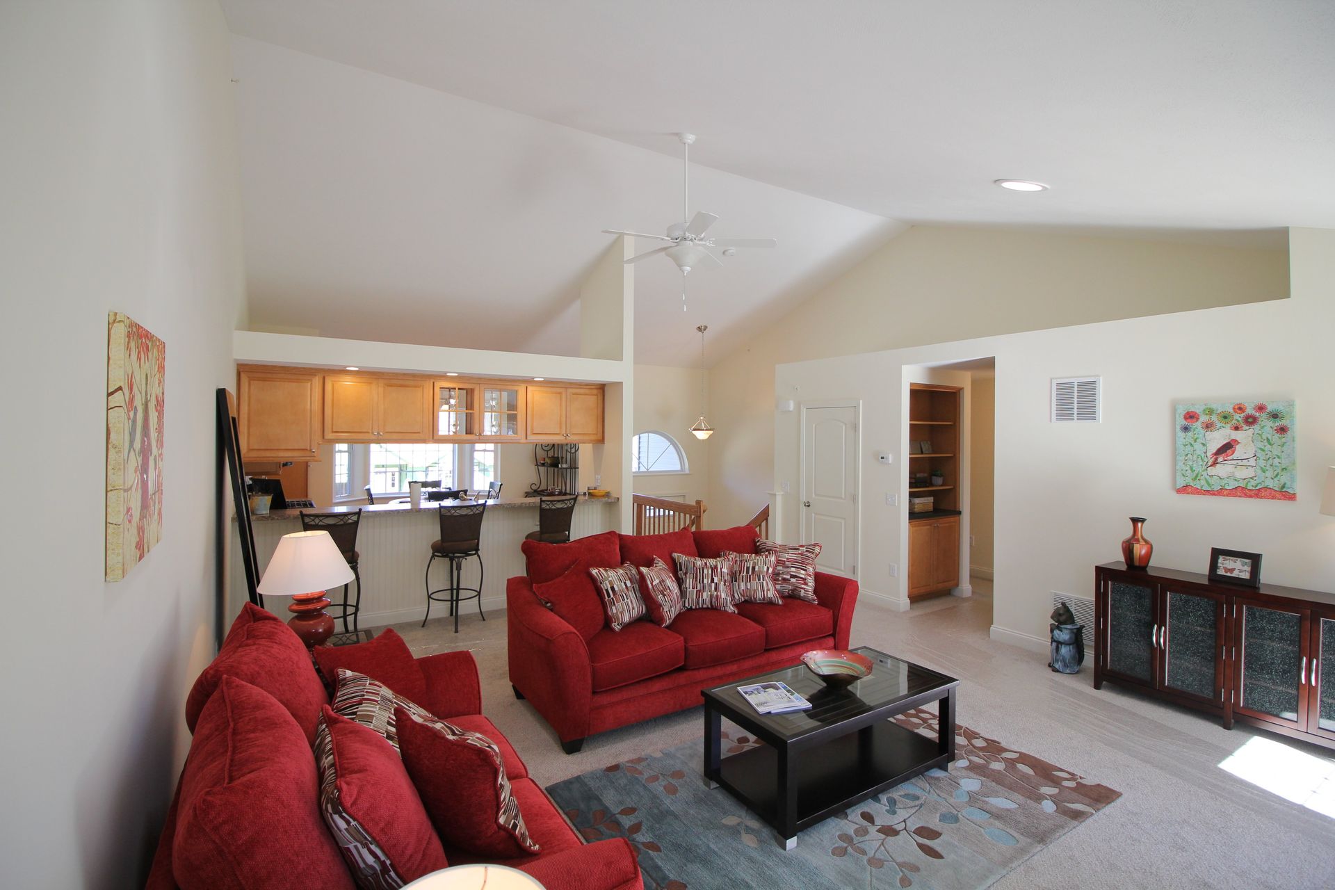 A living room with a red couch and a coffee table