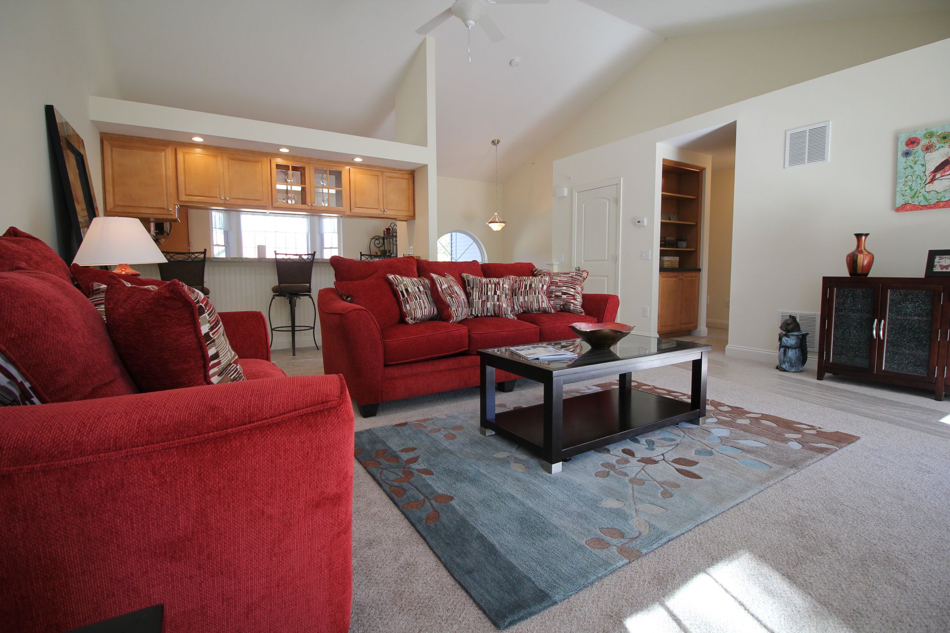 A living room with a red couch and a coffee table