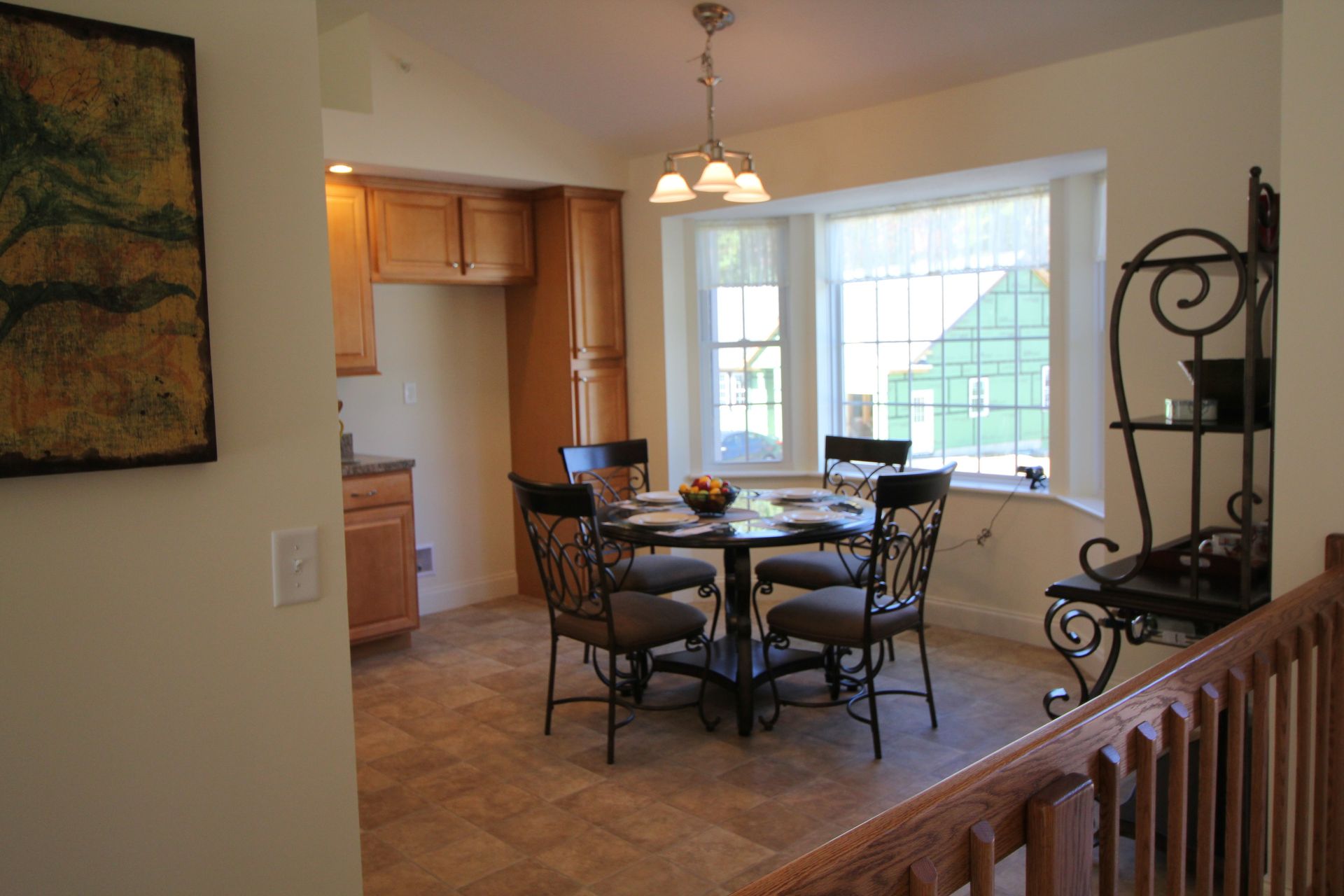 A dining room with a table and chairs and a window
