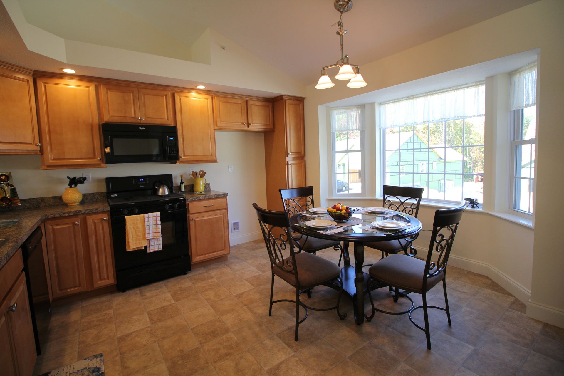 A kitchen with a table and chairs and a window