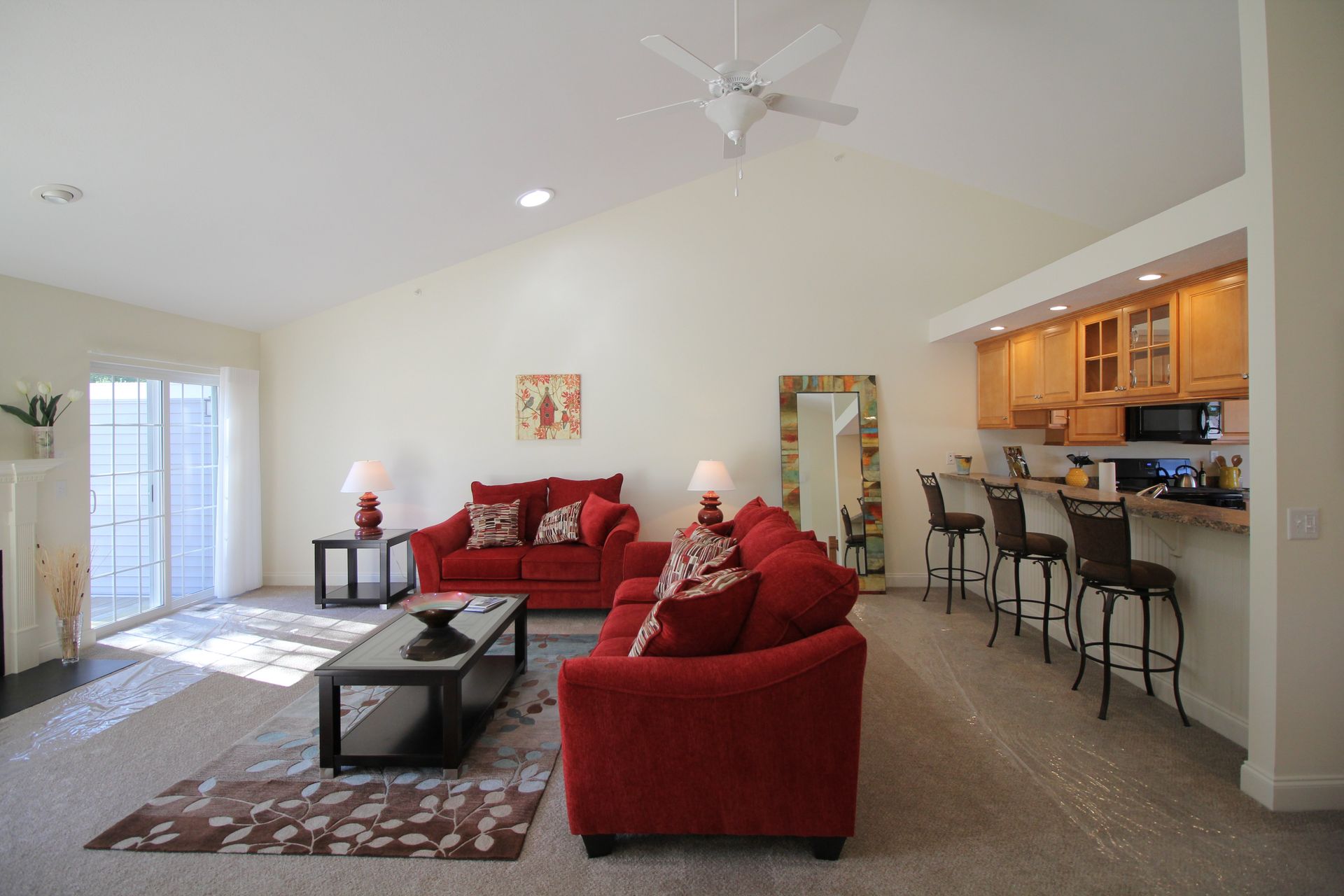 A living room with a red couch and a coffee table