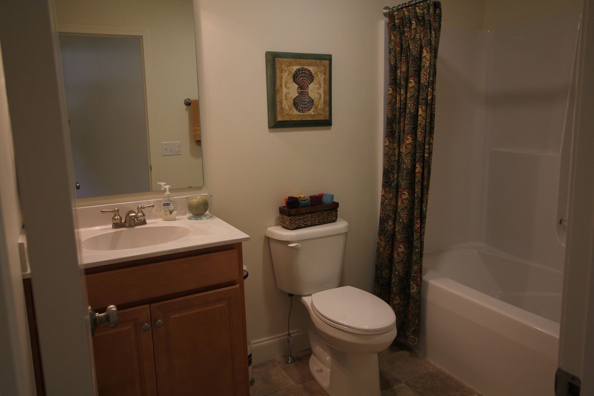 A bathroom with a toilet , sink , and bathtub.