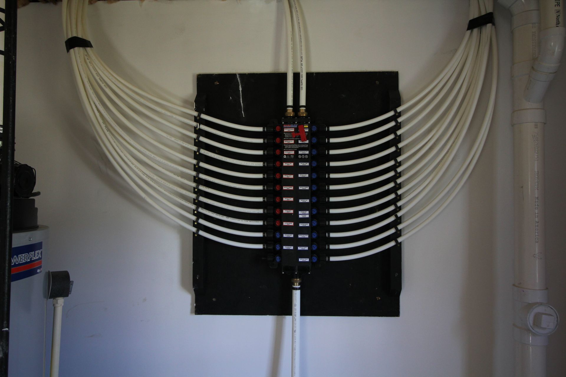 A bunch of wires are hanging from a wall