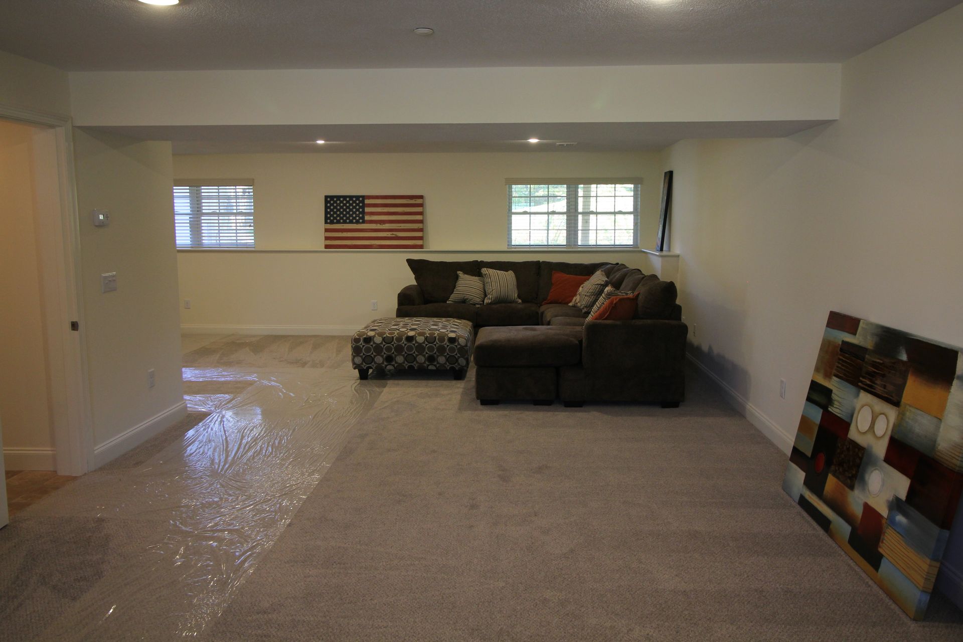 A living room with a couch and a painting on the wall