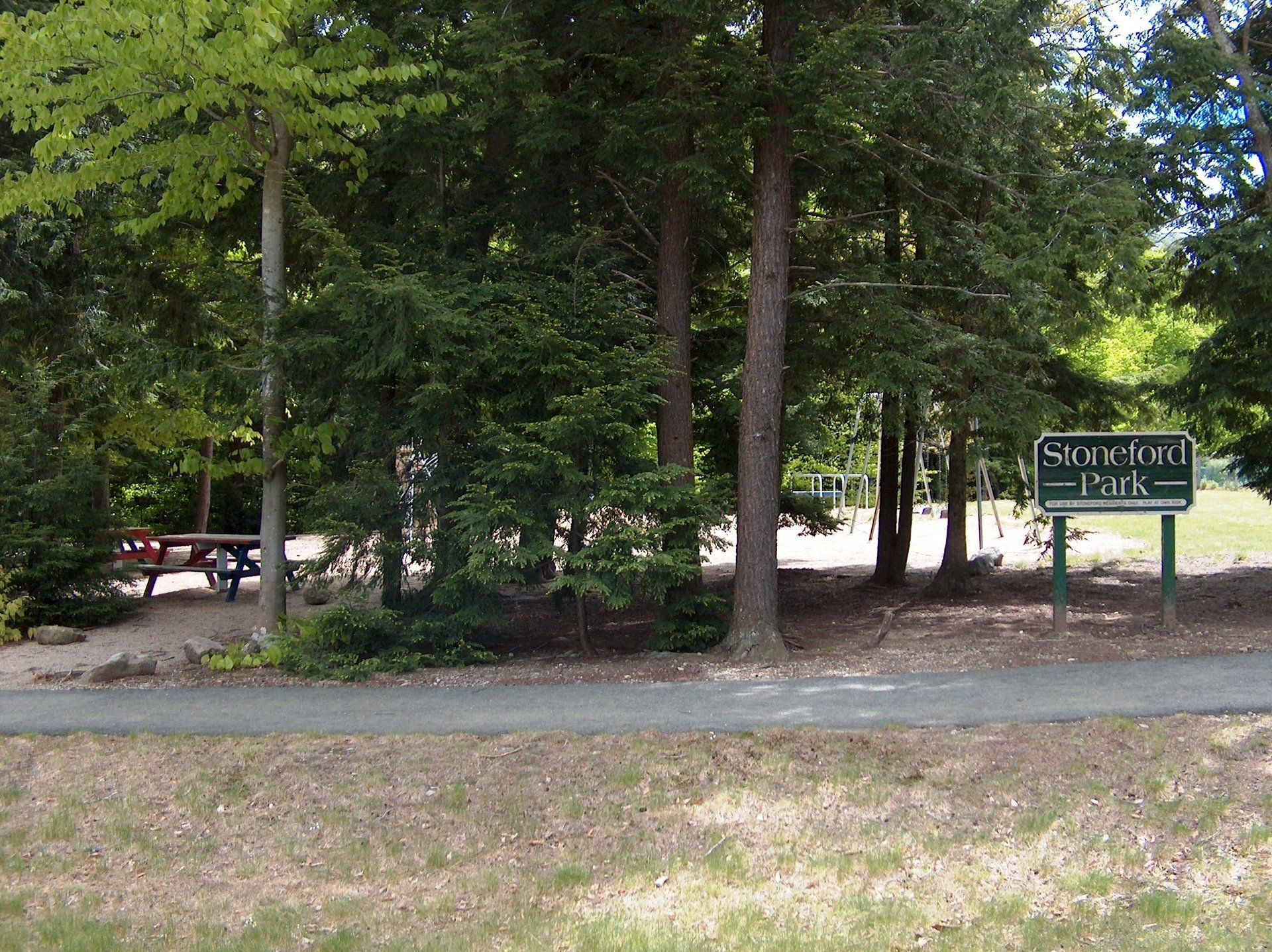 A park with trees and a sign that says shingle park